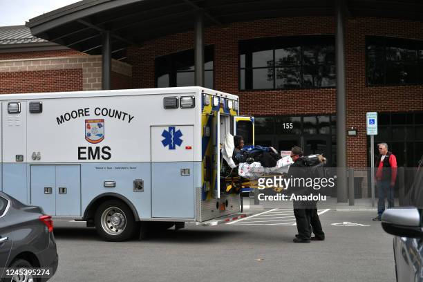 An ambulance is seen in front of a hospital without electricity as tens of thousands are without power on Moore County after an attack at two...