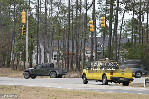 Unlit traffic lights are seen as tens of thousands are without power on Moore County after an attack at two substations by Duke Electric were shot at...