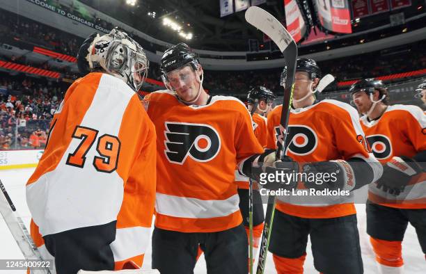 Nick Seeler and Carter Hart of the Philadelphia Flyers celebrate with their teammates after defeating the Colorado Avalanche 5-3 at the Wells Fargo...