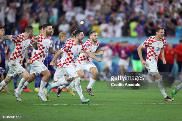 Croatia players celebrate after winning the penalty shoot out during the FIFA World Cup Qatar 2022 Round of 16 match between Japan and Croatia at Al...
