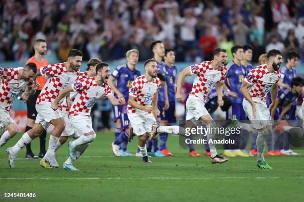 Croatia players celebrate after winning the penalty shoot out during the FIFA World Cup Qatar 2022 Round of 16 match between Japan and Croatia at Al...
