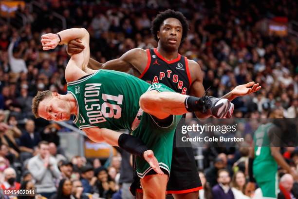 Anunoby of the Toronto Raptors and Blake Griffin of the Boston Celtics get tangled up during the second half of their NBA game at Scotiabank Arena on...