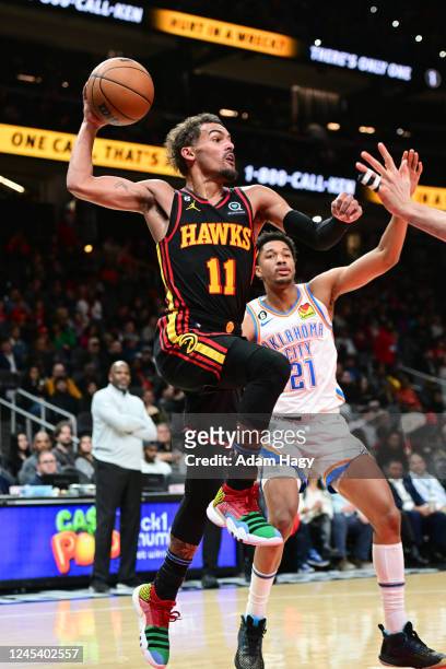 Trae Young of the Atlanta Hawks passes the ball during the game against the Oklahoma City Thunder on December 5, 2022 at State Farm Arena in Atlanta,...