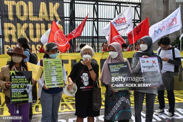 This picture taken on December 5, 2022 shows activists holding a protest against the new criminal code outside the parliament building in Jakarta. -...
