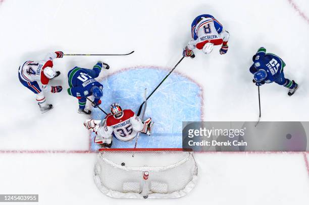 Elias Pettersson of the Vancouver Canucks scores a goal on Sam Montembeault of the Montréal Canadiens in overtime during their NHL game at Rogers...