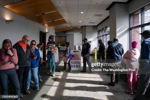 People are seen in line to vote on the first day of early voting in Cobb County on Saturday, November 26, 2022 in Marietta, GA.