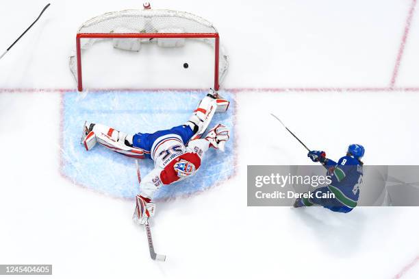 Conor Garland of the Vancouver Canucks scores a goal on Sam Montembeault of the Montréal Canadiens during the second period of their NHL game at...