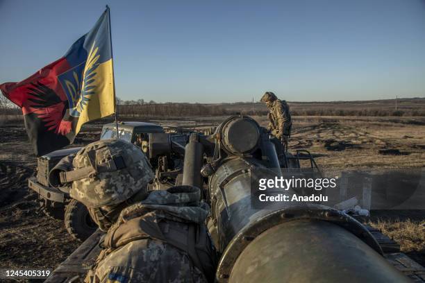 Ukrainian servicemen ride on top of an artillery system in the frontline of Donbas, Ukraine on December 05, 2022.