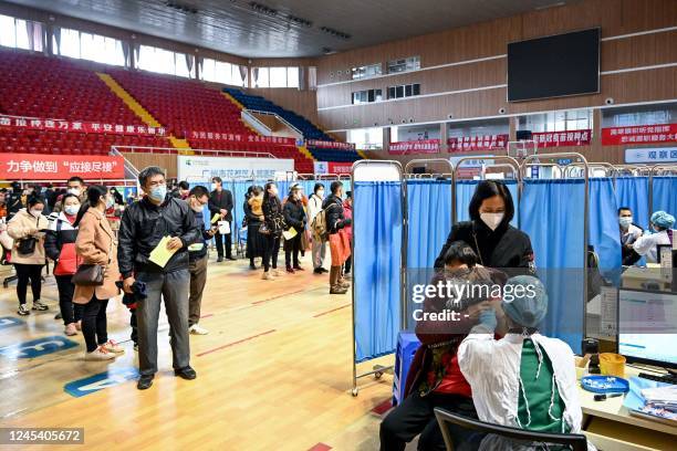 Resident receives a Covid-19 vaccine in Guangzhou, in China's southern Guangdong province on December 6, 2022. - China OUT / China OUT