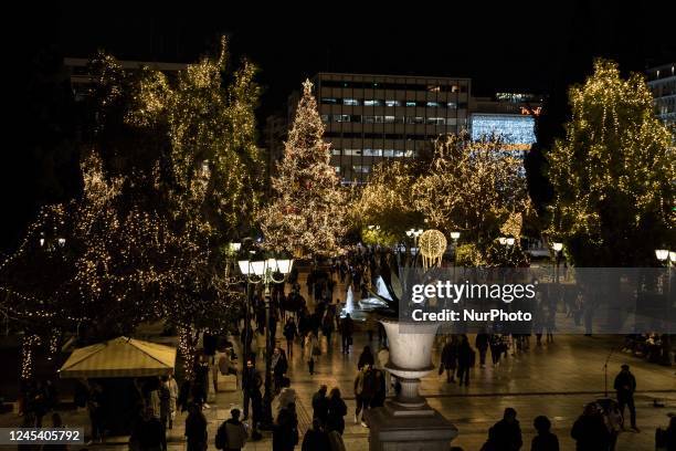 People walk around the Athens Christmas tree at central Syntagma square in Athens, on Monday, Dec. 5, 2022.