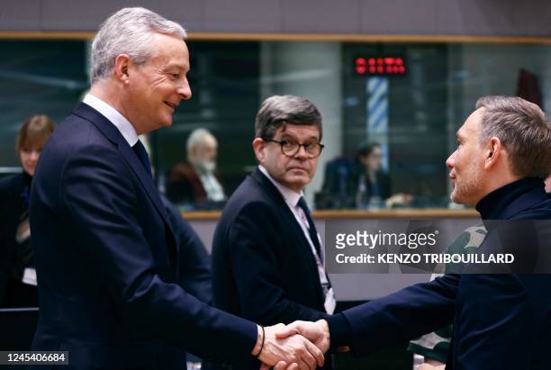France's Minister for the Economy and Finance Bruno Le Maire shakes hands with German federal minister for finance Christian Lindner before an...