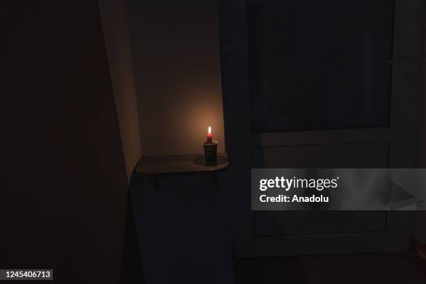 Candle is seen during blackout resulted from missile attacks on power plants and water system as Russia-Ukraine war continues in Odessa, Ukraine on...