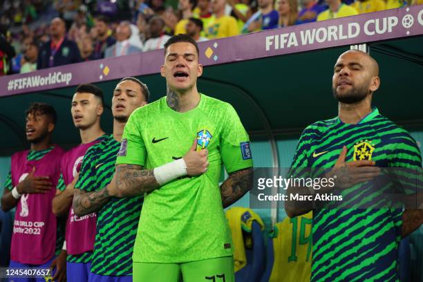 Fred, Gabriel Martinelli, Antony, Ederson and Dani Alves of Brazil sing the national anthem prior to the FIFA World Cup Qatar 2022 Round of 16 match...