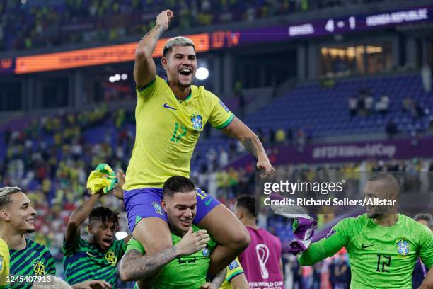 Bruno Guimaraes of Brazil on Ederson of Brazil shoulders after the FIFA World Cup Qatar 2022 Round of 16 match between Brazil and South Korea at...