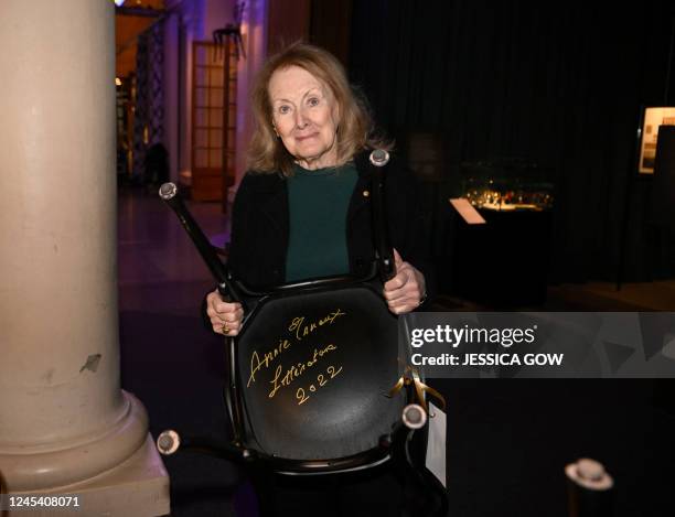 Nobel Prize in Literature 2022 laureate French writer Annie Ernaux holds a chair she signed at the Nobel Prize Museum in Stockholm, on December 6,...