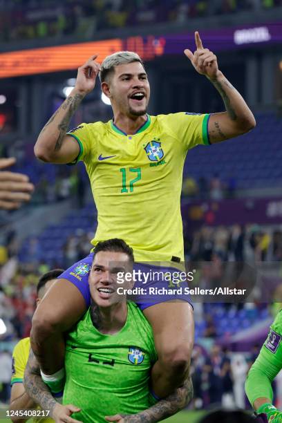 Bruno Guimaraes of Brazil on Ederson of brazil shoulders after the FIFA World Cup Qatar 2022 Round of 16 match between Brazil and South Korea at...
