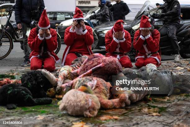 "Extinction Rebellion" gestures in front of stuffed toys covered with paint during an action to denounce the government's environmental policy on the...