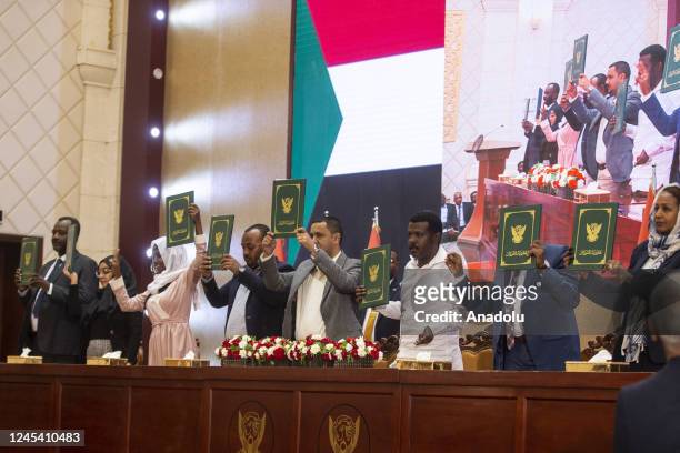 Participants hold and pose with the framework agreement at the Friendship Congress and Meeting Hall in Khartoum, Sudan on December 05, 2022. The...