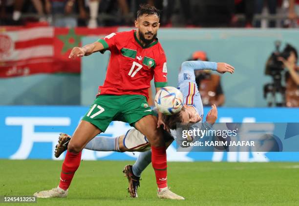 Morocco's midfielder Sofiane Boufal fights for the ball with Spain's midfielder Gavi during the Qatar 2022 World Cup round of 16 football match...