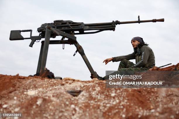 Turkey-backed Syrian fighter sits at a position on the outskirts of the town of Marea, in the northern Aleppo countryside, along the frontline with...