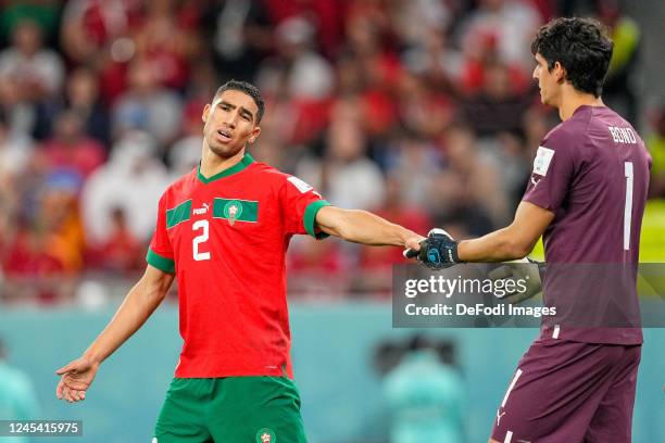 Achraf Hakimi of Morocco and goalkeeper Yassine Bounou of Morocco shake hands and look dejected during the FIFA World Cup Qatar 2022 Round of 16...