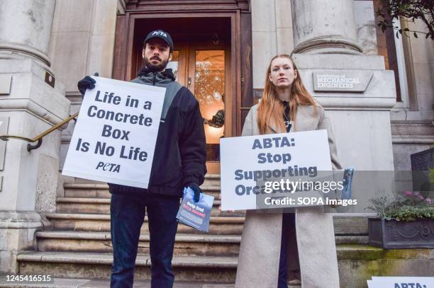 Protesters hold placards opposed to keeping marine animals in captivity during the demonstration. PETA activists staged a protest outside the...