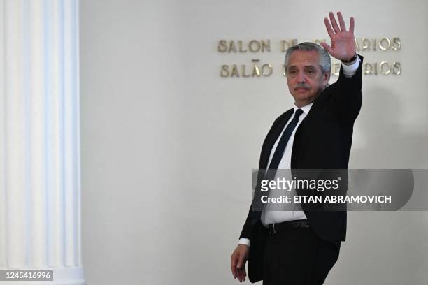 Argentina's President Alberto Fernandez waves while leaving at the end of the Mercosur heads of state summit and associated countries in Montevideo...