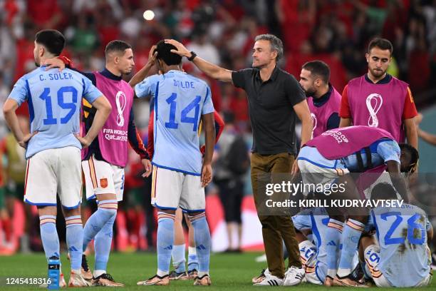 Spain's coach Luis Enrique console Spain's defender Alejandro Balde after they lost the Qatar 2022 World Cup round of 16 football match between...