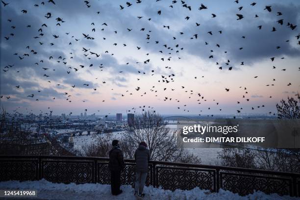 Flock of crows flies over downtown Kyiv on December 6 amid the Russian invasion of Ukraine. - With temperatures dipping below zero, repeated Russian...