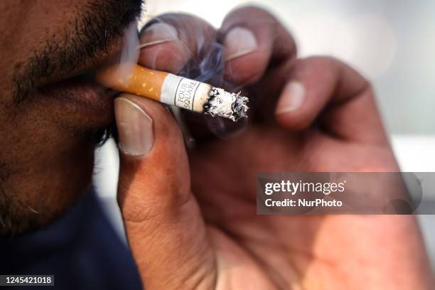 Boy smokes Four Square cigerette in Baramulla Jammu and Kashmir India on 06 December 2022