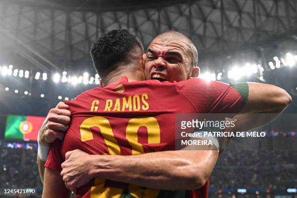 Portugal's forward Goncalo Ramos celebrates with Portugal's defender Pepe after he scored his team's first goal during the Qatar 2022 World Cup round...
