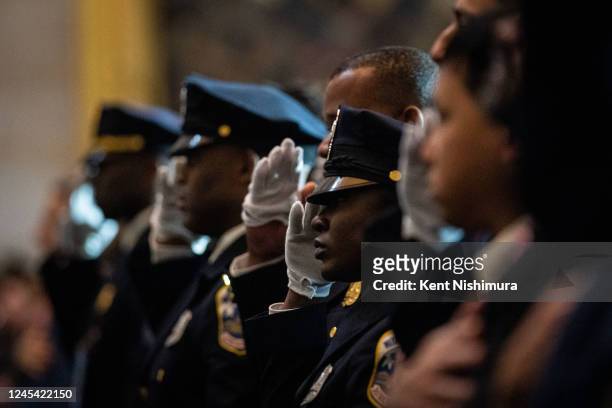 Law enforcement officers salute during a Congressional Gold Medal Ceremony in honor of the US Capitol Police and those who protected the Capitol in...