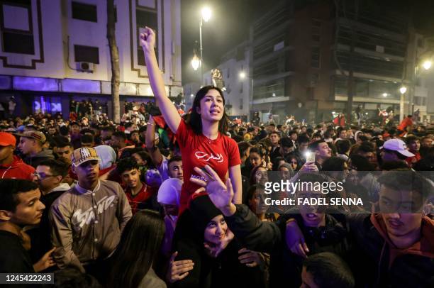 Moroccans celebrate their team's victory after the Qatar 2022 World Cup round of 16 football match between Morocco and Spain, in Rabat, on December...