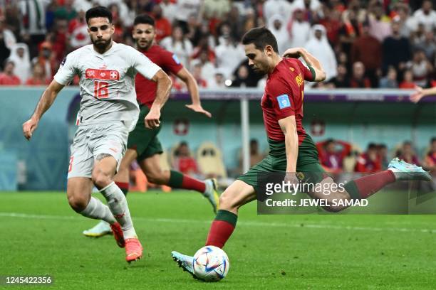 Portugal's defender Raphael Guerreiro kicks to ball to score his team's fourth goal during the Qatar 2022 World Cup round of 16 football match...