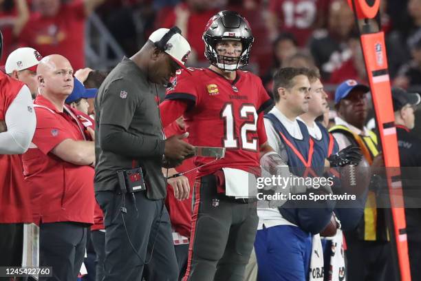 Tampa Bay Buccaneers Offensive Coordinator Byron Leftwich talks with Quarterback Tom Brady along the sidelines during the regular season game between...