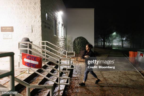 Person walks towards a polling location during the runoff election in Atlanta, Georgia, US, on Tuesday, Dec. 6, 2022. Georgia voters Tuesday will...