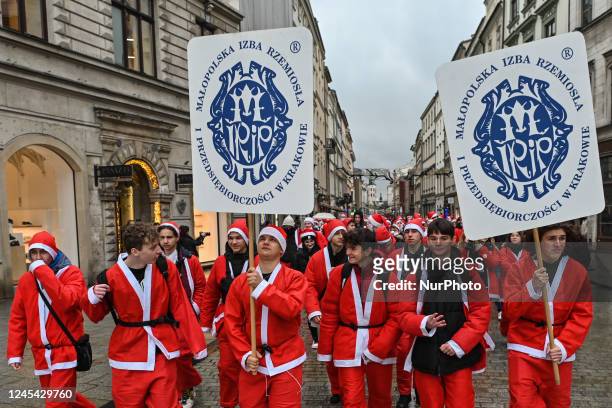 Santas are seen during the Santa Parade in Krakow's Old Town. Pupils of the School of Crafts and Entrepreneurship dressed in Santa Claus costumes...