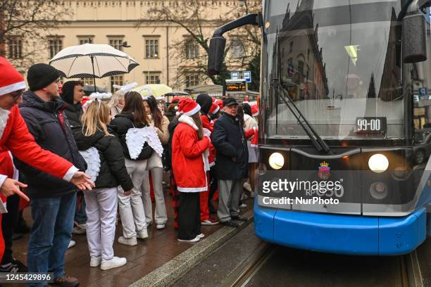 Santas wait to enter a special Santa Tram to deliver gifts to young patients of the Zeromski Hospital in Krakow. Pupils of the School of Crafts and...