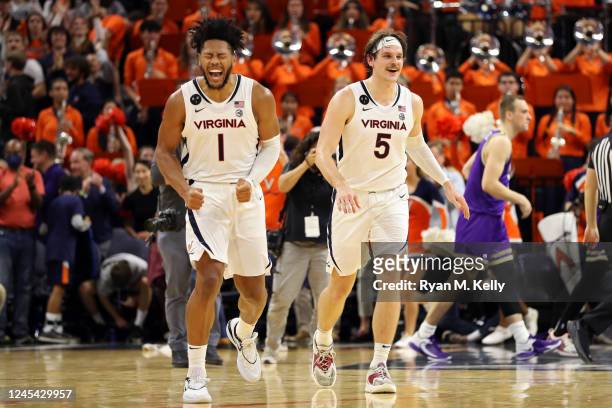 Jayden Gardner and Ben Vander Plas of the Virginia Cavaliers celebrate defeating the James Madison Dukes after a game at John Paul Jones Arena on...