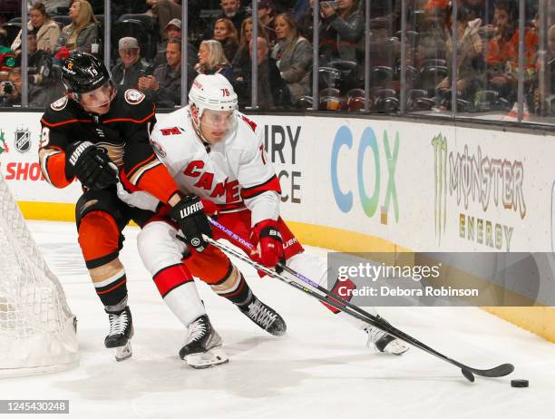 Troy Terry of the Anaheim Ducks and Brady Skjei of the Carolina Hurricanes battle for position during the second period at Honda Center on December...