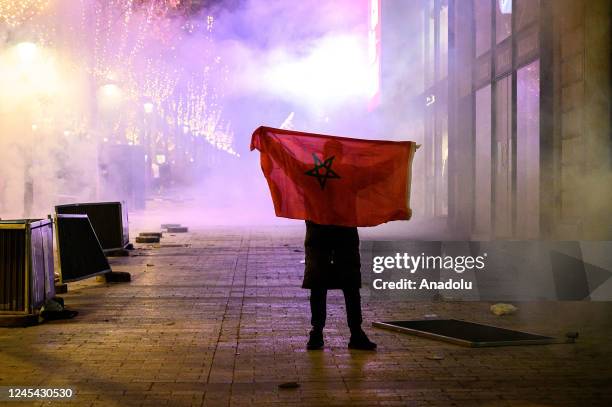 Fans clash with police as Moroccan supporters celebrate victory as Morocco qualified for 2022 FIFA World Cup quarterfinals after beating Spain on...