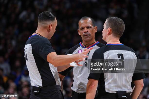 Referees Ray Acosta, Eric Lewis, and Nick Burchert huddle up during the game between the Dallas Mavericks and the Denver Nuggets on December 6, 2022...