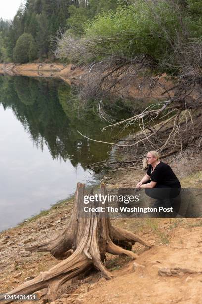 Laura Nelson looks out onto the water while participating in a forest therapy walk for individuals impacted by wildfire in Butte County at Paradise...