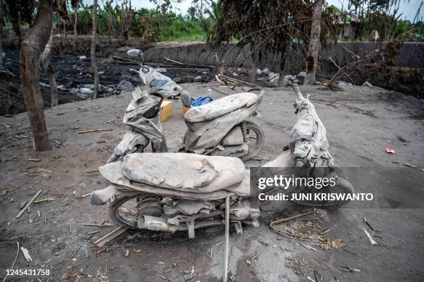 Damaged motorcyles are covered in ash at Kajar Kuning village in Lumajang on December 7 following the volcanic eruption of mount Semeru on December 4.