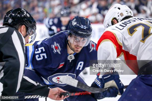Mark Scheifele of the Winnipeg Jets gets set for a second period face-off against Eetu Luostarinen of the Florida Panthers at the Canada Life Centre...
