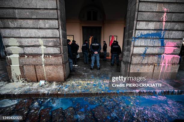 Police officers detain environmental activists from the "Last Generation" group after they smeared with paint the facade of the La Scala theatre...