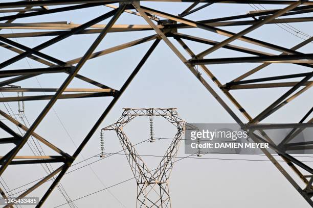 Photograph shows electric pylons in the countryside of Saint-Laurent-de-Terregatte, western France on December 6, 2022. - France may face "some days"...