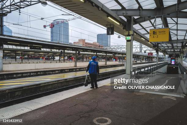 Employee stands on an empty platform at Lyon Part-Dieu railway station, on December 7, 2022 during a strike by railways workers to call for pay...