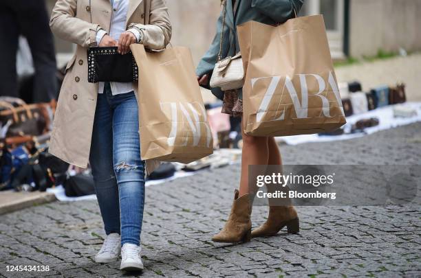 Shoppers carry Zara bags in Lisbon, Portugal, on Tuesday, Dec. 6, 2022. Inflation in the European Union is reaching its peak, according to Economy...