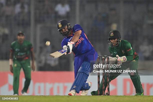 India's captain Rohit Sharma plays a shot during the second one-day international cricket match between Bangladesh and India at the Sher-e-Bangla...